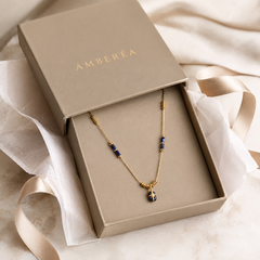 AMBERÉA Blue Lapis Pendant Necklace | Gold Starburst Luxury Necklace